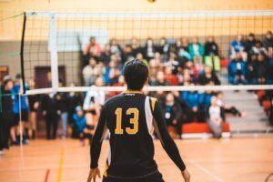 man wearing black 13 volleyball jersey